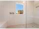 Modern walk-in shower with white tile walls and neutral floor tiles at 128 Los Cabos Dr # 302, Las Vegas, NV 89144