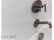 A close-up of a shower with white subway tiles and modern bronze fixtures at 128 Los Cabos Dr # 302, Las Vegas, NV 89144