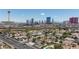 Aerial view showing residential neighborhood and a skyline shot featuring the city's prominent towers at 1700 Ivanhoe Way, Las Vegas, NV 89102