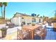 Backyard patio featuring palm trees, seating area, and dining table at 1700 Ivanhoe Way, Las Vegas, NV 89102