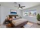 Bedroom featuring wood floor, ceiling fan, and large windows at 1700 Ivanhoe Way, Las Vegas, NV 89102