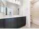 Modern bathroom vanity with large mirror and adjacent bath and shower at 1801 Flycatch St, Las Vegas, NV 89138