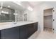 Bathroom featuring double sinks, modern lighting and a glass enclosed shower at 1801 Flycatch St, Las Vegas, NV 89138