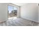 Bright bedroom featuring plush carpet, neutral walls, and sliding glass doors to an outdoor balcony at 1801 Flycatch St, Las Vegas, NV 89138