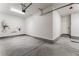 Spacious garage with concrete floor, white walls, overhead lighting, and side door at 1801 Flycatch St, Las Vegas, NV 89138