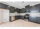 Modern kitchen with stainless steel appliances, sleek dark cabinets, and light countertops at 1801 Flycatch St, Las Vegas, NV 89138
