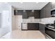 Open kitchen featuring stainless steel appliances, dark cabinets, and light countertops at 1801 Flycatch St, Las Vegas, NV 89138