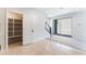 Living room with neutral tile flooring, a walk-in pantry and sliding glass doors to the exterior at 1801 Flycatch St, Las Vegas, NV 89138
