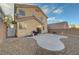 Cozy backyard features a unique concrete patio and low-maintenance desert landscaping at 189 Paxon Hollow Ct, Las Vegas, NV 89148