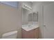 Well-lit bathroom featuring a single sink vanity with neutral countertops, cabinets, and a large mirror at 189 Paxon Hollow Ct, Las Vegas, NV 89148