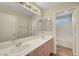 Bathroom with double sinks, a large mirror, and a view into the shower and toilet area at 189 Paxon Hollow Ct, Las Vegas, NV 89148