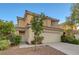 Two-story home with a tile roof, two-car garage, and manicured landscaping at 189 Paxon Hollow Ct, Las Vegas, NV 89148