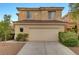 Two-story home with a tile roof, two-car garage, and manicured landscaping at 189 Paxon Hollow Ct, Las Vegas, NV 89148