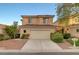 Two-story home with a tile roof, two-car garage, and manicured landscaping at 189 Paxon Hollow Ct, Las Vegas, NV 89148
