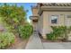 Charming home featuring a well-maintained yard with lush green bushes and a concrete walkway to the front door at 189 Paxon Hollow Ct, Las Vegas, NV 89148