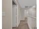 Upstairs hallway with carpet, white railing, and access to multiple rooms at 189 Paxon Hollow Ct, Las Vegas, NV 89148