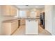 Kitchen features light wood cabinets, granite counters, and island for seating at 189 Paxon Hollow Ct, Las Vegas, NV 89148