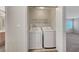 This is a laundry room featuring a washer, dryer, and shelving at 189 Paxon Hollow Ct, Las Vegas, NV 89148