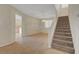 Inviting living area with tile floors, neutral walls, chandelier lighting, and a staircase at 189 Paxon Hollow Ct, Las Vegas, NV 89148