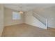 Spacious living area features tile floors, neutral walls, chandelier lighting and a staircase at 189 Paxon Hollow Ct, Las Vegas, NV 89148