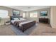 Staged main bedroom featuring carpet flooring, neutral walls, and a calming color palette at 189 Paxon Hollow Ct, Las Vegas, NV 89148