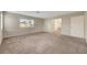 A spacious main bedroom with carpet, window, and view of bathroom at 189 Paxon Hollow Ct, Las Vegas, NV 89148