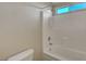 Clean white tiled shower and tub combination with a window for natural light at 189 Paxon Hollow Ct, Las Vegas, NV 89148
