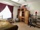 Cozy bedroom with carpet flooring, window, ceiling fan, and a workspace at 213 Luninborg St, Henderson, NV 89074