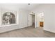 Bright bedroom featuring a large arched window and elegant wood-look flooring at 2251 Wigwam Pkwy # 424, Henderson, NV 89074