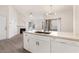Modern kitchen island featuring stainless steel sink, faucet, white cabinets, and Amana dishwasher at 2251 Wigwam Pkwy # 424, Henderson, NV 89074