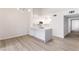 Bright kitchen with white cabinets, an island with countertop seating and stainless steel appliances at 2251 Wigwam Pkwy # 424, Henderson, NV 89074