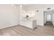 Bright kitchen with white cabinets, an island with countertop seating and stainless steel appliances at 2251 Wigwam Pkwy # 424, Henderson, NV 89074