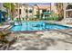 Large outdoor swimming pool with lounge chairs and mature shade trees near the property at 2251 Wigwam Pkwy # 424, Henderson, NV 89074