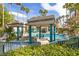 View of a luxurious pool with shade structures, lounge chairs and lush greenery in a tropical setting at 2251 Wigwam Pkwy # 424, Henderson, NV 89074