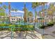 Resort-style pool area with palm trees, multiple buildings and lush landscaping under a bright, sunny sky at 2251 Wigwam Pkwy # 424, Henderson, NV 89074