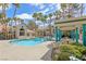 Exterior shot of pool and clubhouse with tropical landscaping, lounge chairs, and shade area at 2251 Wigwam Pkwy # 424, Henderson, NV 89074