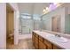 Bathroom with double sinks, a shower-tub combo and tiled floors in neutral colors at 2509 April Breeze Ln, Henderson, NV 89002