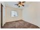 Spare bedroom with a ceiling fan, neutral walls and floors and a small window at 2509 April Breeze Ln, Henderson, NV 89002