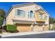 Two-story townhouse with a three car garage and a small balcony in a residential area at 2509 April Breeze Ln, Henderson, NV 89002