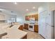 Compact kitchen featuring modern appliances, wooden cabinetry and a large sink at 2509 April Breeze Ln, Henderson, NV 89002