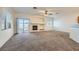 Open concept living room with a fireplace and sliding glass doors to the backyard at 2509 April Breeze Ln, Henderson, NV 89002