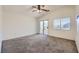 Bedroom with a ceiling fan, neutral walls, and a sliding glass door to a balcony at 2509 April Breeze Ln, Henderson, NV 89002