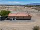 Aerial rear view of home featuring desert landscaping and HVAC unit at 2530 Commercial Dr, Pahrump, NV 89048