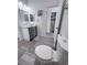 Bathroom view with grey cabinets, modern fixtures and vinyl floors at 2530 Commercial Dr, Pahrump, NV 89048