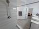 Bathroom view with updated shower, vessel sinks, and a view into the bedroom at 2530 Commercial Dr, Pahrump, NV 89048