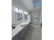 Stylish bathroom with double vanity, modern lighting, and a glass-enclosed shower with a built-in niche at 2530 Commercial Dr, Pahrump, NV 89048