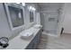 Bright bathroom featuring double sinks, modern fixtures, and a luxurious glass-enclosed shower at 2530 Commercial Dr, Pahrump, NV 89048
