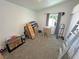 Bedroom with carpet flooring, a window, and a ladder at 2530 Commercial Dr, Pahrump, NV 89048