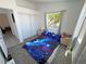 Bedroom view with carpet floors, a window and a galaxy themed bedspread at 2530 Commercial Dr, Pahrump, NV 89048