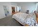 Clean bedroom offers carpet, light walls, access to an organized closet, and an adjacent bathroom at 2530 Commercial Dr, Pahrump, NV 89048